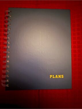 Navy Spiral Notebook with Yellow "PLANS" Cover
